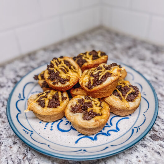 Baked cheeseburger bites on a plate.