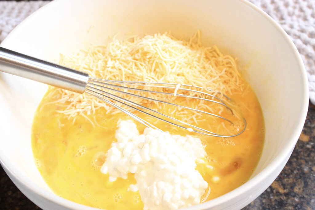 Beat eggs, cottage cheese, and shredded cheese.