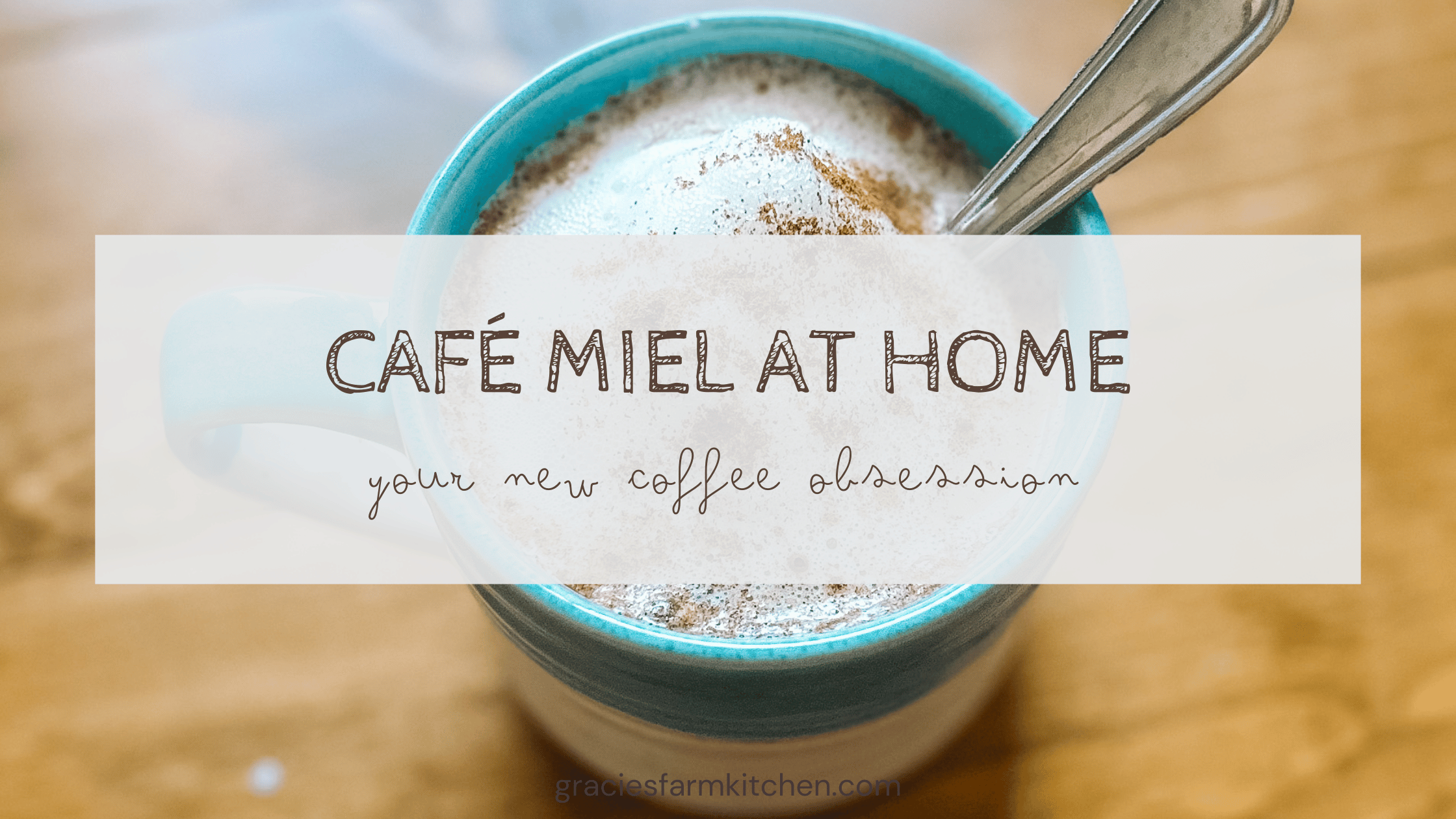 cafe miel in a blue ceramic mug with a silver spoon